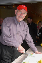 Father Harrington cuts his Celebratory Cake